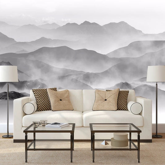 Living room with a white sofa, decorative pillows, and a mountain mural in the background.