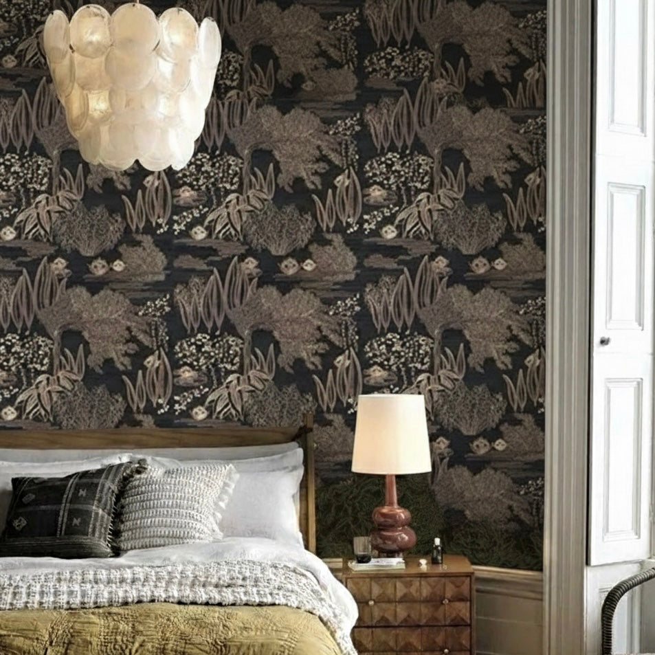 Bedroom with dark floral wallpaper, bed, lamp, and nightstand.