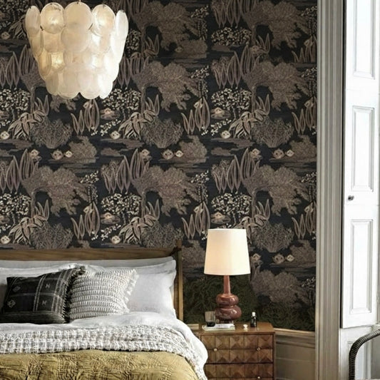 Bedroom with dark floral wallpaper, bed, lamp, and nightstand.
