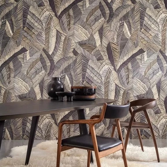 Dining room with a leaf patterned wall, table, and chairs.