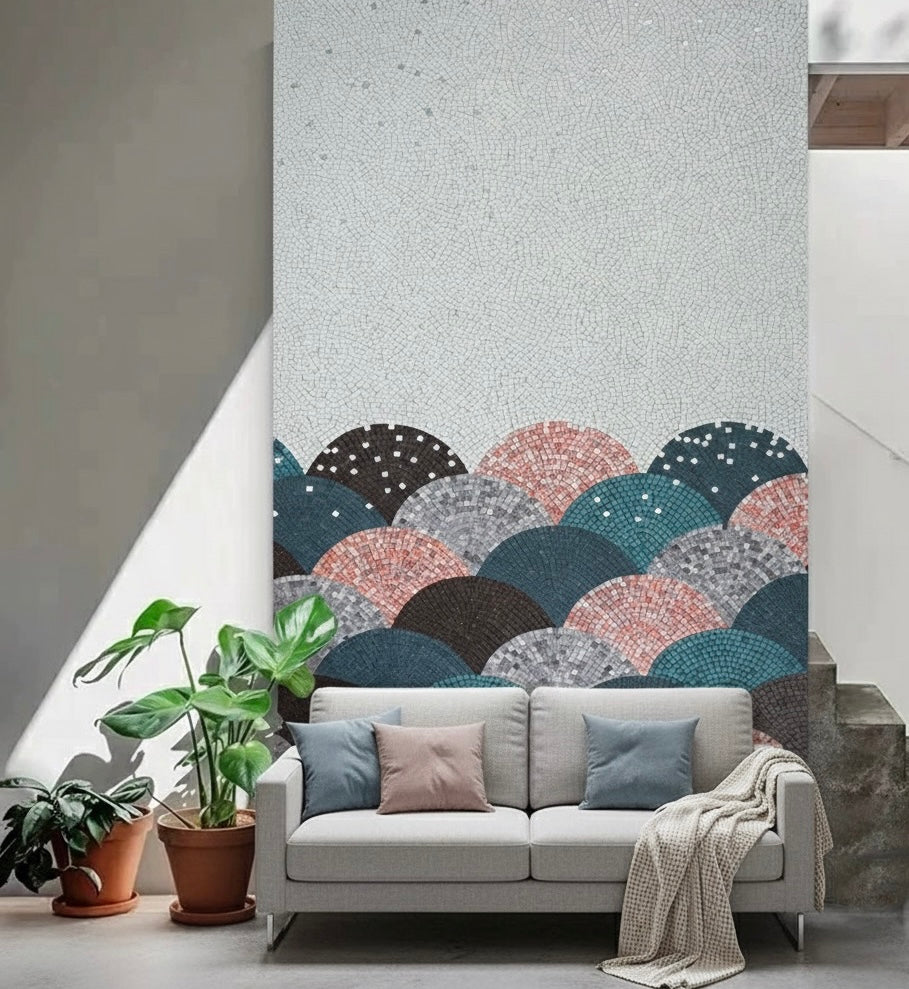 Gray sofa with decorative pillows in a room with a mosaic mural.