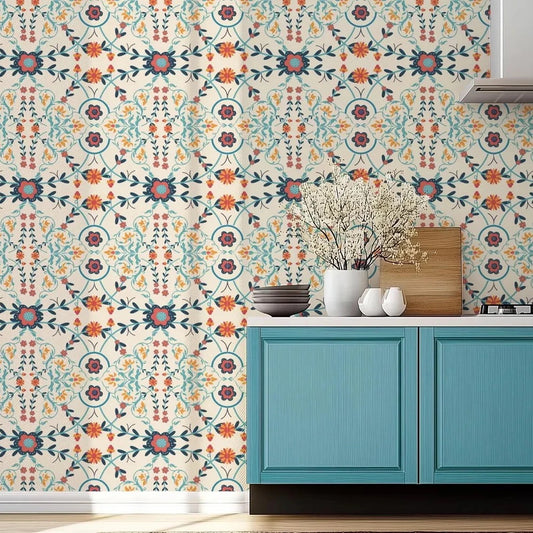 Teal cabinet with decorative items against a floral patterned wall.