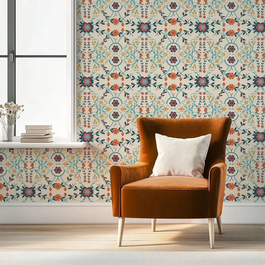 Brown armchair with a white pillow against a wall with decorative floral wallpaper.
