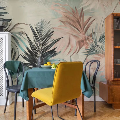 Dining room with a yellow chair, teal tablecloth, and tropical wall mural.