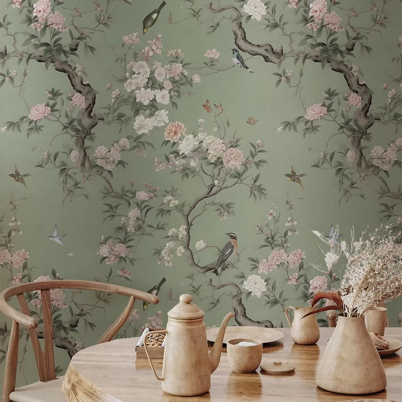 Dining room with floral wallpaper mural, wooden chair, and table setting.