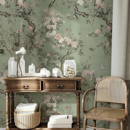 Decorative room interior with floral wallpaper mural, wooden console table, and wicker chair.