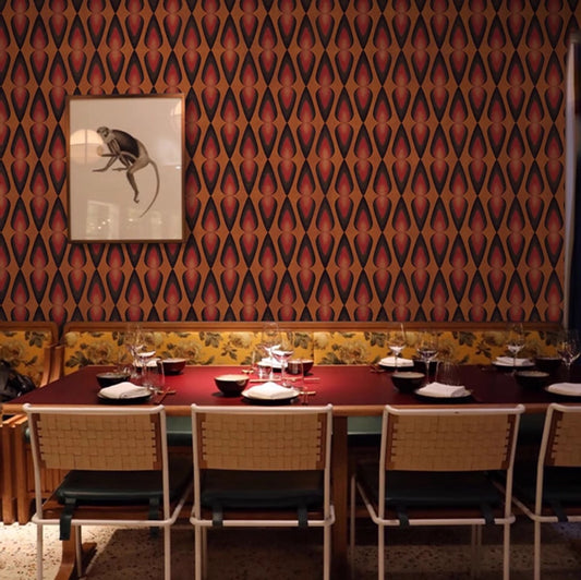 Dining area with patterned wall, table, chairs, and artwork.