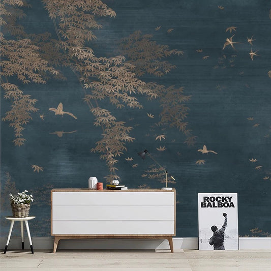 Room interior with a white dresser, small table, and decorative items against a dark wall with tree and bird mural.