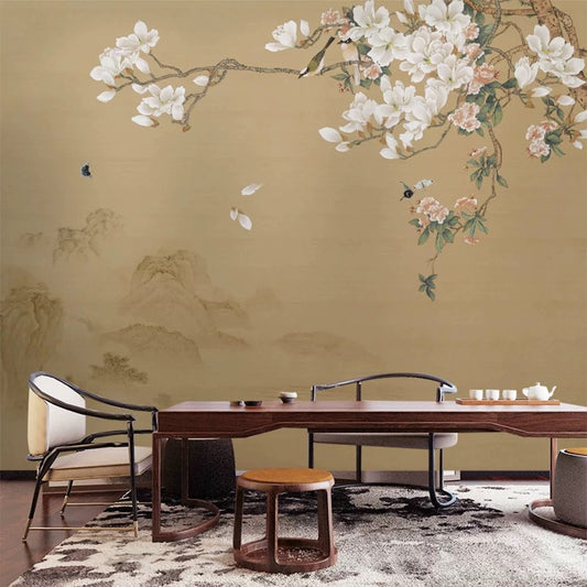 Dining room with a large wall mural of floral branches and mountains.