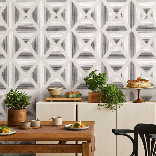 Dining room with geometric wallpaper, table, chairs, and decorative items.