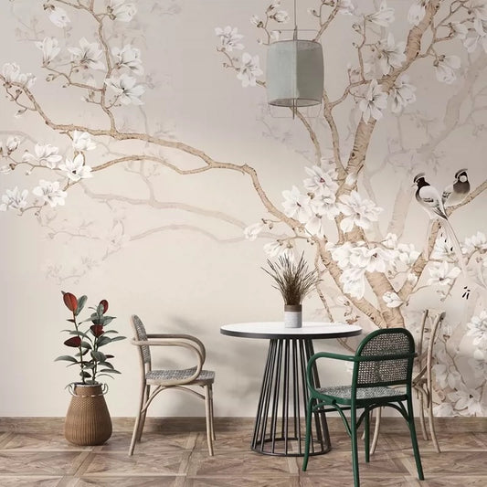 Dining area with a round table and chairs against a floral wall mural.