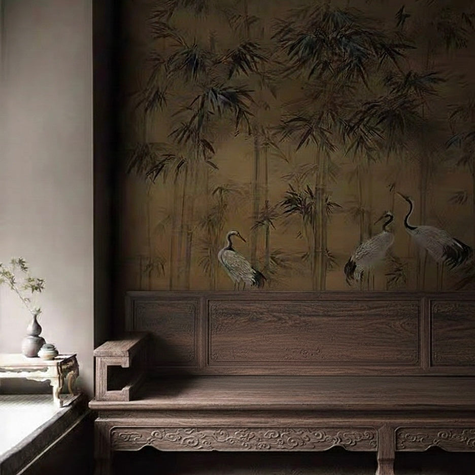 Moody living room with a dark wood bench against a Chinoiserie bamboo and crane mural.