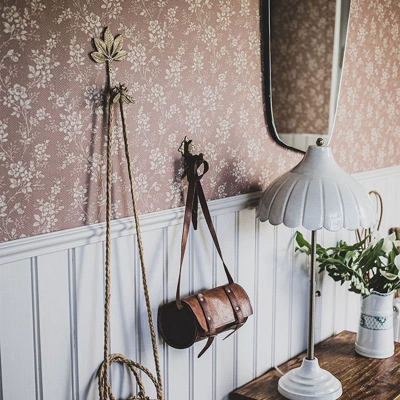 Vintage-style room with floral wallpaper, wooden paneling, and decorative items.