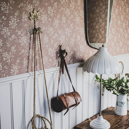Vintage-style room with floral wallpaper, wooden paneling, and decorative items.