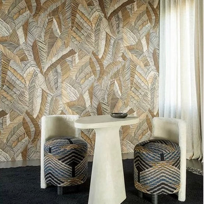 Room with leaf patterned wallpaper, white table, and patterned stools.
